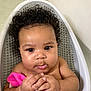 Navi is registered to the contest to win money with this photo: baby, bath, bathtub, child, closeup, curly_hair, cute, expression, face, hands, indoors, infant, person, pink_cloth, playful, portrait, seated, skin, water, young_child