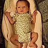baby, infant, blanket, onesie, toy, duck, sleeping_bag, soft, cute, newborn, child, portrait, clothing, lying_down, indoor, warm_light, resting, person, small, cozy