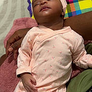Jeleesa participe au concours pour gagner de l'argent avec cette photo : baby, sleeping, infant, onesie, pink_clothing, hand, blanket, pattern, cherry, person, resting, cozy, soft, toddler, indoor, human, cute, care, child, holding