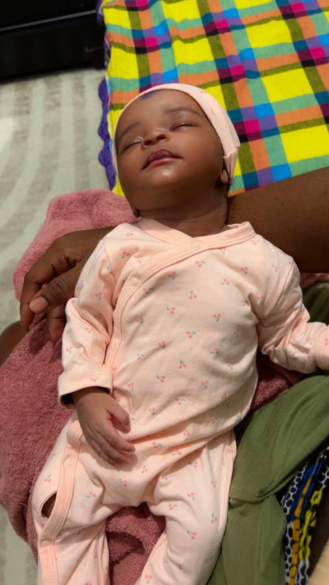 Jeleesa participe au concours pour gagner de l'argent avec cette photo : baby, sleeping, infant, onesie, pink_clothing, hand, blanket, pattern, cherry, person, resting, cozy, soft, toddler, indoor, human, cute, care, child, holding