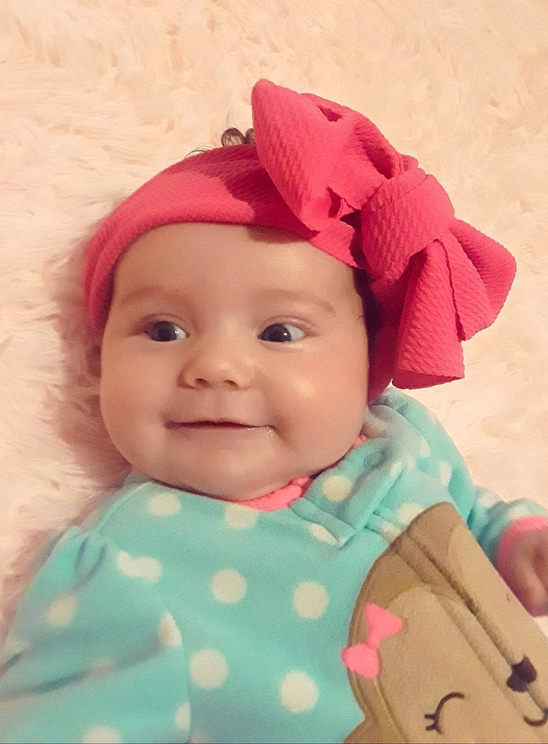 Emberly is registered to the contest to win money with this photo: baby, cheek, child, face, head, headgear, headwear, joy, lip, person, pink, skin, smile, toddler