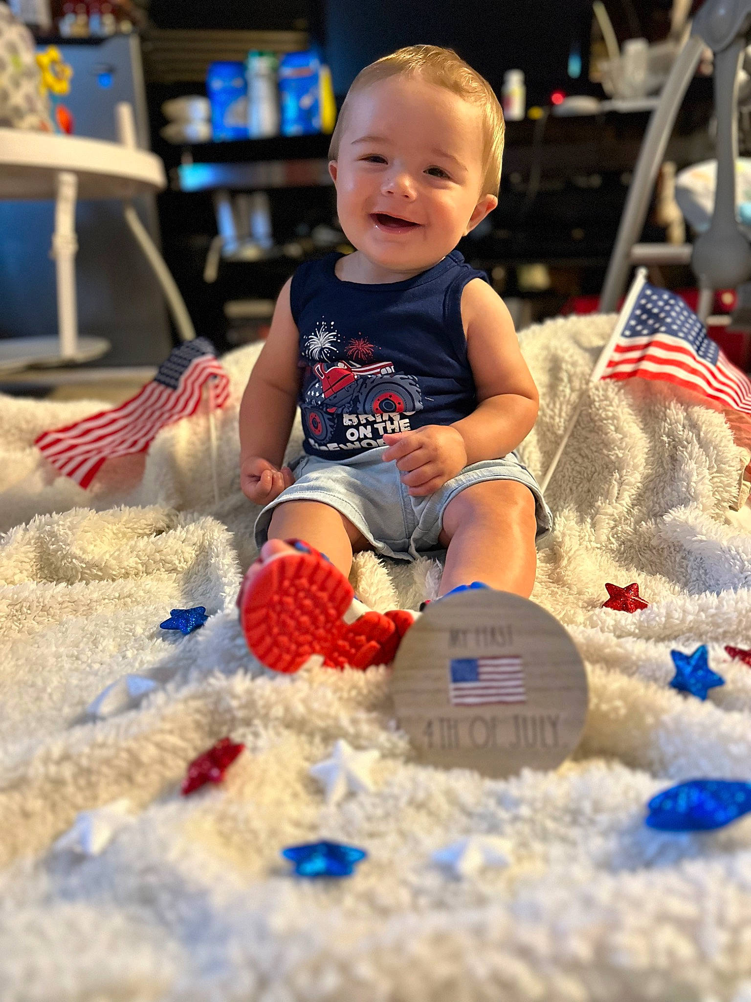 Elliot is registered to the contest to win money with this photo: baby, baby_toddler_clothing, baby_toys, blue, chair, child, electric_blue, event, flooring, fun, happy, holiday, joy, leisure, person, play, sand, shelf, sitting, smile