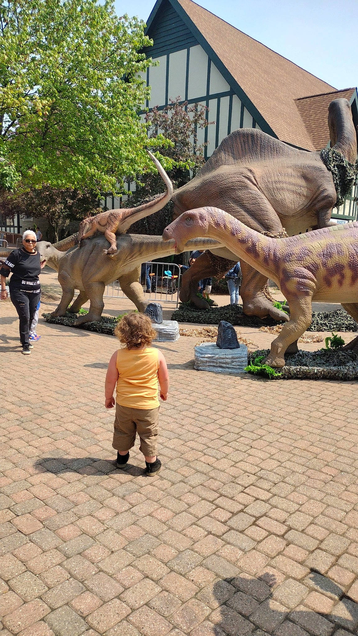Caleb Charles is registered to the contest to win money with this photo: art, dinosaur, elephant, elephants_and_mammoths, extinction, fun, indian_elephant, leisure, organism, person, plant, recreation, sculpture, shorts, statue, temple, terrestrial_animal, toddler, tree, tusk