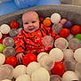 Bella-Rose joined the competition — help win amazing prizes! baby, ball_pit, child, closeup, colorful, cute, face, fun, happy, head, indoor, infant, leisure, orange_clothing, person, plastic_balls, playful, seated, smiling, toy