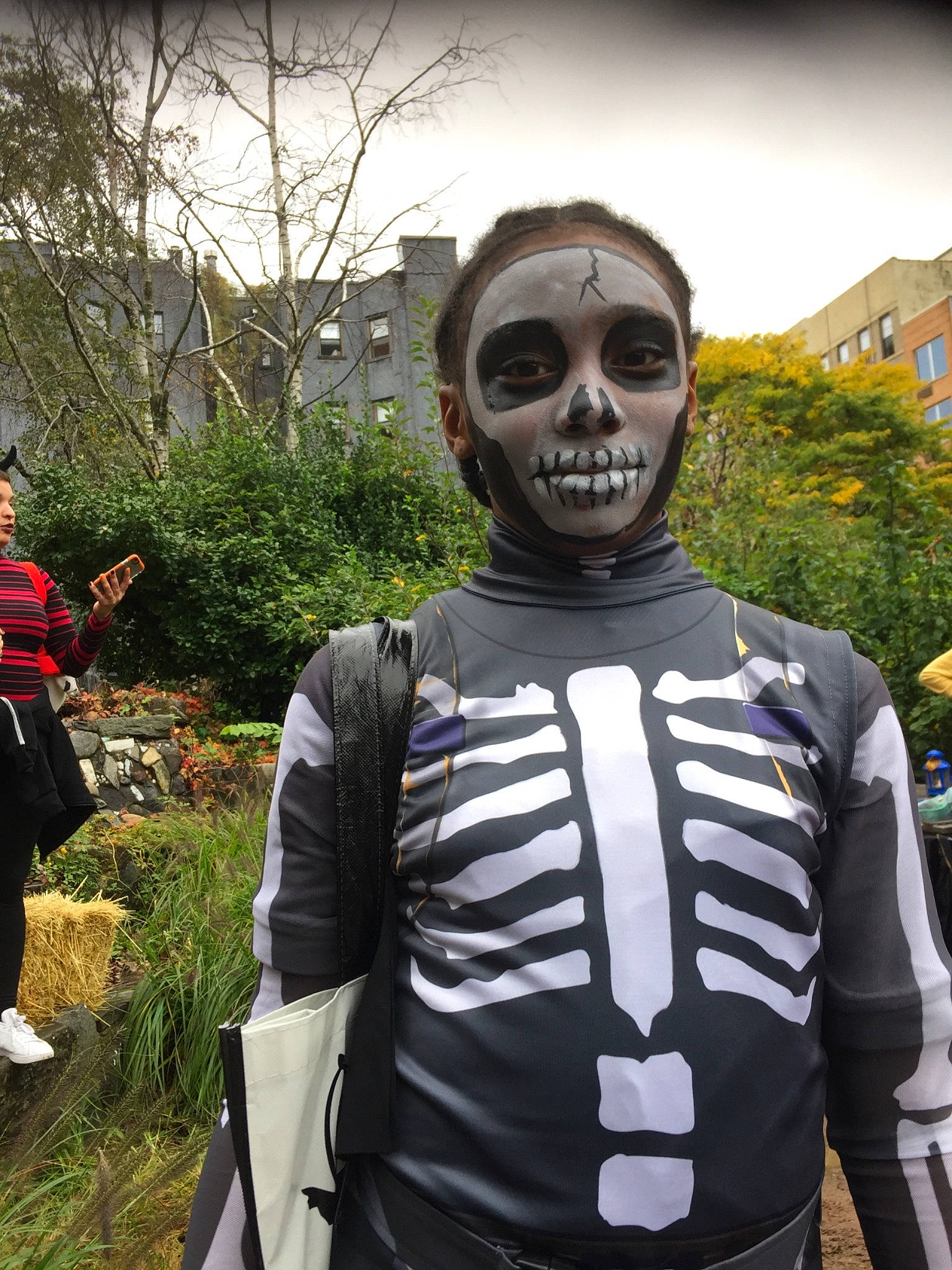 Denise is registered to the contest to win money with this photo: cool, costume, fiction, fictional_character, joy, person, personal_protective_equipment, photography, recreation, skeleton, skull, t_shirt, tourism, walking