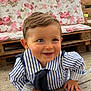 baby, child, smile, striped_shirt, navy_tie, crawling, wooden_deck, face, blue_eyes, hair, furniture, couch, floral_pattern, outdoor, daylight, cute, happy, person, portrait, infant