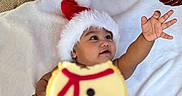 Saayan joined the competition — help win amazing prizes! baby, blanket, celebration, child, christmas, christmas_ornament, christmas_tree, cookie, cute, decorations, face, festive, hand, holiday, holiday_season, indoor, reaching, santa_hat, smiling, snowman_cookie