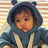 Saayan is registered to the contest to win money with this photo: baby, child, hoodie, blue_clothing, high_chair, indoor, closeup, face, big_eyes, curious, cute, infant, soft_lighting, straps, seated, fleece, warm_clothing, person, portrait, expression