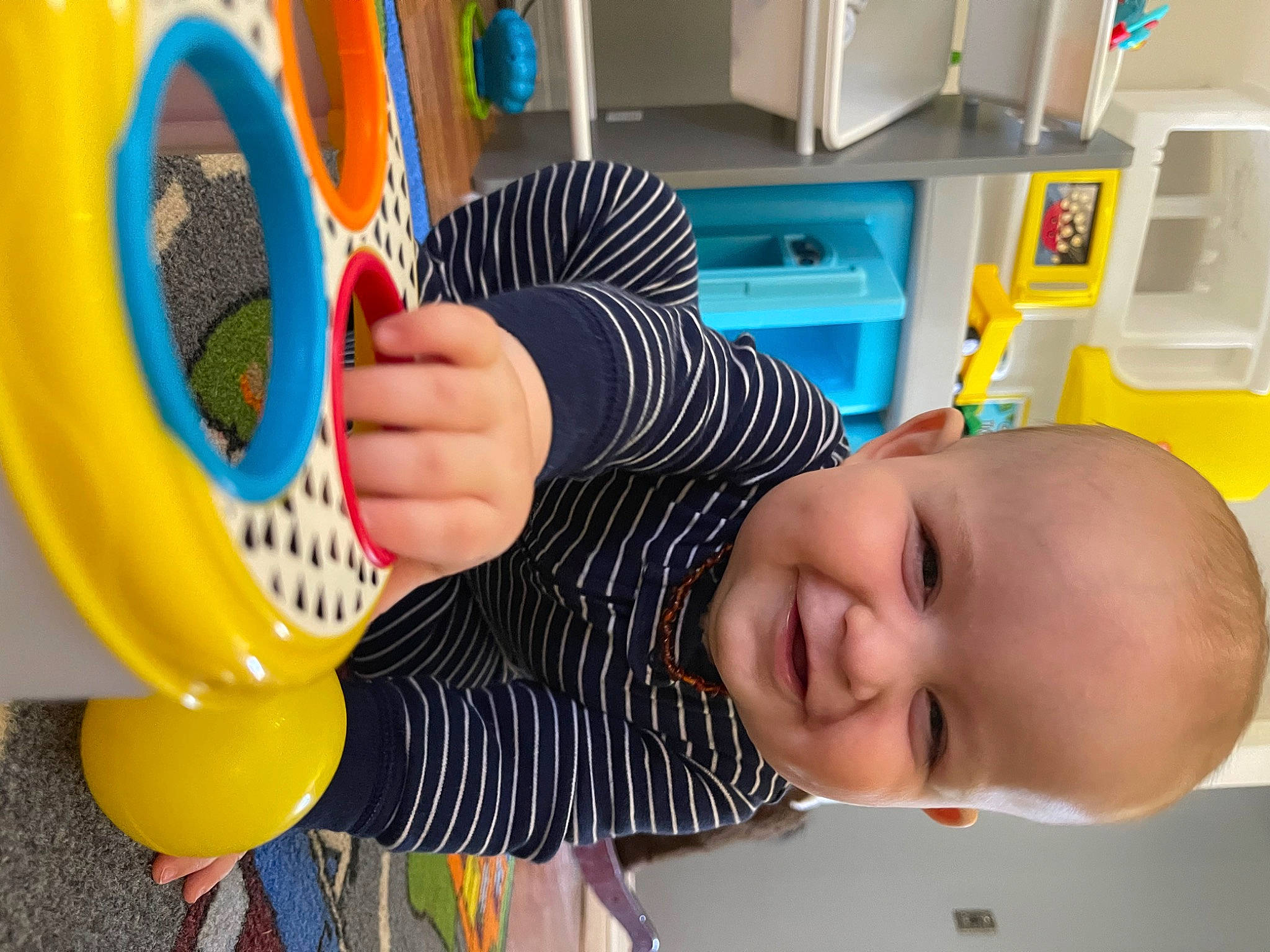 Beckett joined the competition — help win amazing prizes! arm, baby, baby_products, baby_toddler_clothing, baby_toys, child, electric_blue, finger, fun, happy, orange, person, play, product, room, shelf, shelving, smile, snapshot, toddler