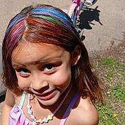 Ailani is registered to the contest to win money with this photo: child, girl, rainbow_hair, smiling, necklace, beads, dress, pastel_colors, bicycle, outdoor, sunlight, car, grass, dandelions, playful, portrait, summer, happy, colorful, toy