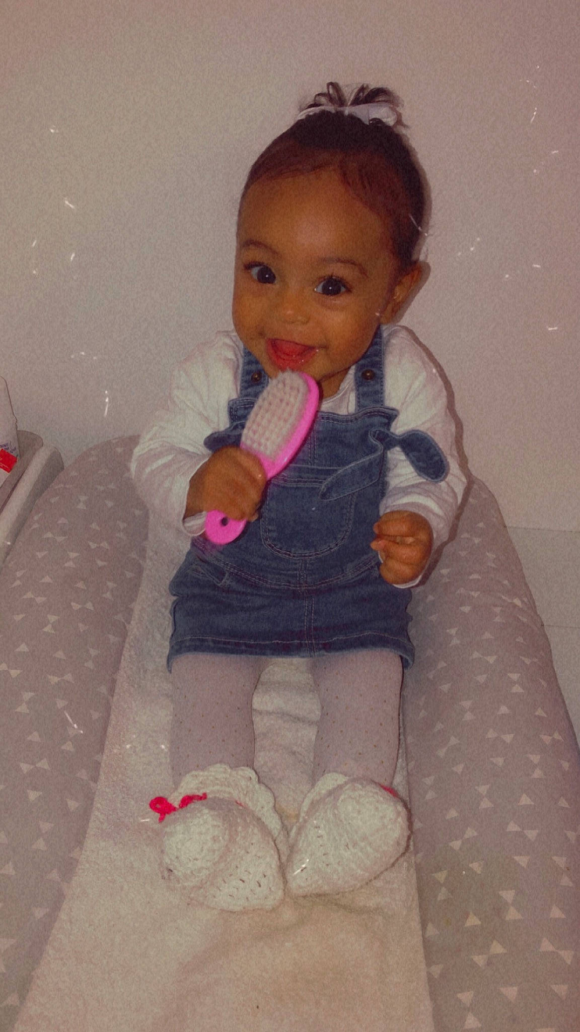 Inaya participe au concours pour gagner de l'argent avec cette photo : art, baby, baby_toddler_clothing, cheek, child, flooring, hand, head, human_body, joy, leg, linens, outerwear, pattern, person, pink, sitting, skin, sleeve, textile