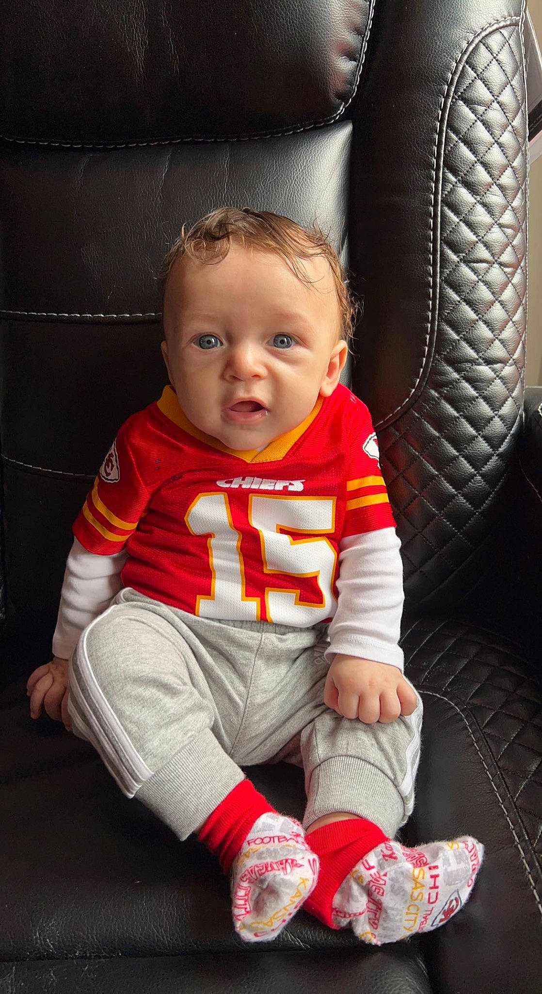 Legacy is registered to the contest to win money with this photo: baby, baby_products, baby_toddler_clothing, carmine, chair, cheek, child, comfort, flash_photography, flooring, fun, human_leg, pattern, person, sitting, skin, sleeve, sock, toddler