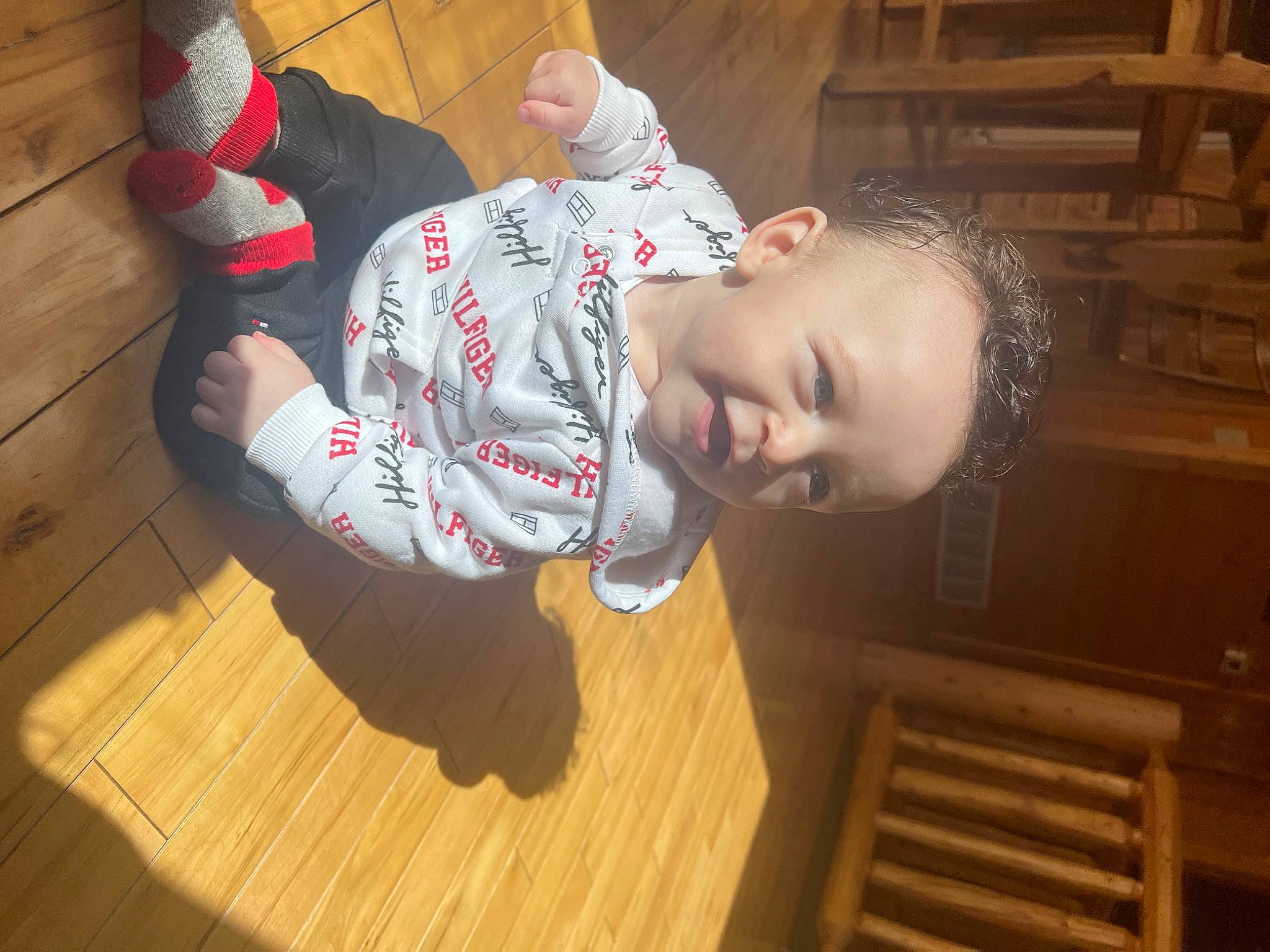 Legacy is registered to the contest to win money with this photo: baby, baby_toddler_clothing, carmine, child, flooring, fun, happy, hardwood, laminate_flooring, pattern, person, plank, room, sitting, sleeve, sock, toddler, varnish, wood, wood_flooring