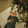 baby, child, christmas_tree, ornaments, candy_cane, blanket, floor, holiday, smile, reindeer_outfit, festive, decorations, indoor, infant, cute, cozy, lights, greenery, happy, celebration