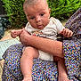 baby, infant, child, person, holding, outdoor, greenery, plants, onesie, california, floral_dress, adult, feet, hands, skin, face, eyes, curious, sitting, garden