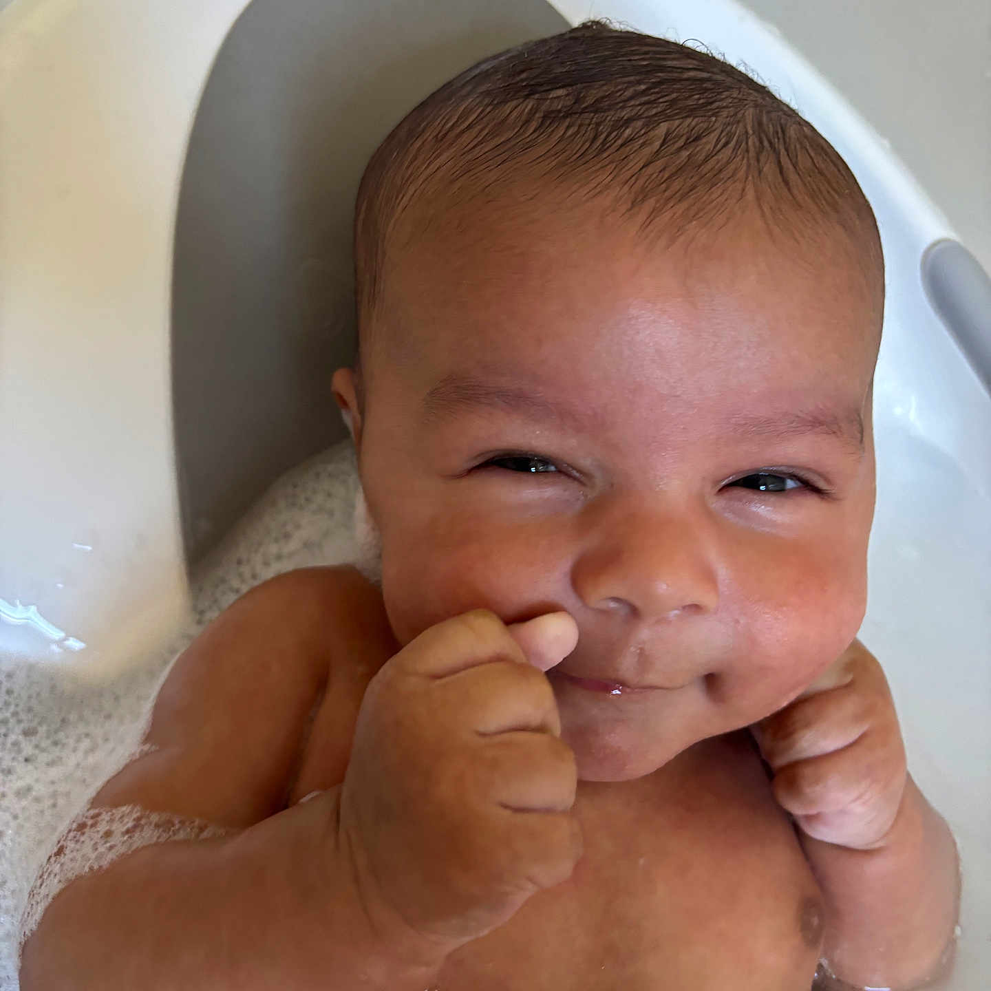 Camil is registered to the contest to win money with this photo: baby, bath, bathtub, bubbles, child, cute, face, happy, infant, inside, little, mischievous, person, playful, portrait, skin, smile, water, young, young_child