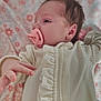 Lilith joined the competition — help win amazing prizes! baby, newborn, pacifier, blanket, onesie, infant, portrait, side_profile, hand, ear, hair, soft_texture, ruffles, sleepwear, cozy, floral_pattern, pink, white, closeup, lying_down