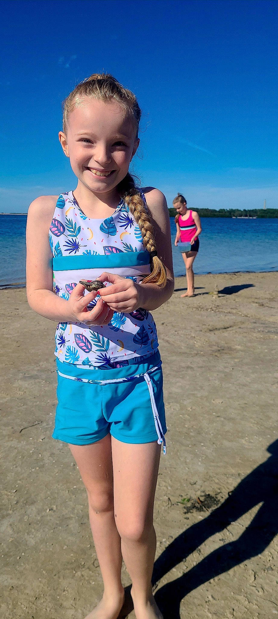 Wednesday is registered to the contest to win money with this photo: beach, beauty, blue, electric_blue, eye, fun, happy, joy, leisure, organ, people_on_beach, person, photograph, recreation, sand, shorts, sky, smile, summer, toddler