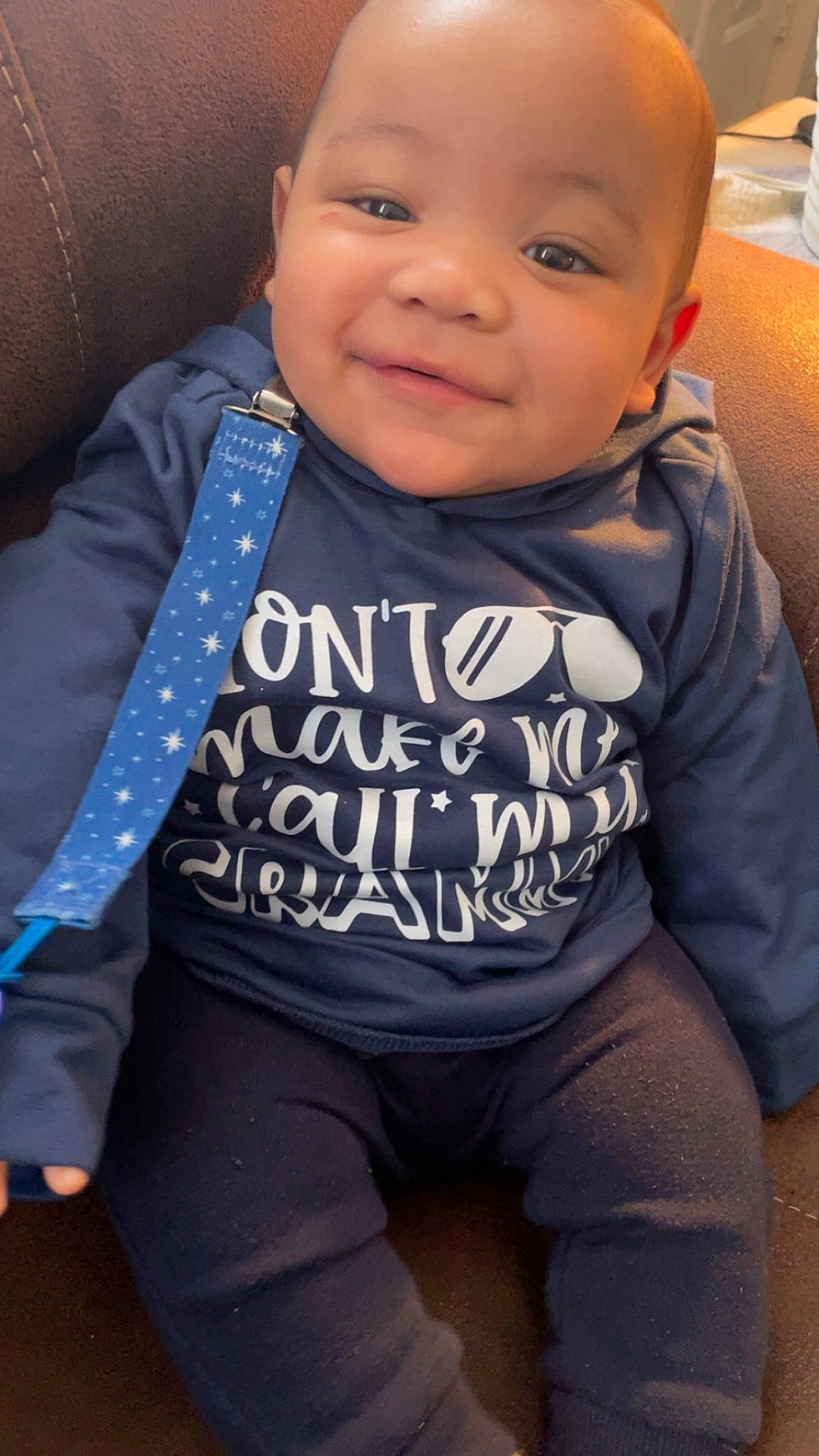 Judah joined the competition — help win amazing prizes! accessories, baby, clothing, coat, couch, cushion, face, formalwear, furniture, happy, head, jacket, jeans, pants, person, photography, portrait, sitting, t_shirt, tie