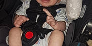 Tony joined the competition — help win amazing prizes! baby, car_seat, child, infant, seatbelt, safety, smile, hand, foot, clothing, fabric, padding, star_pattern, black, white, blue, person, face, indoors, closeup