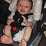 baby, black, blue, car_seat, child, closeup, clothing, fabric, face, foot, hand, indoors, infant, padding, person, safety, seatbelt, smile, star_pattern, white
