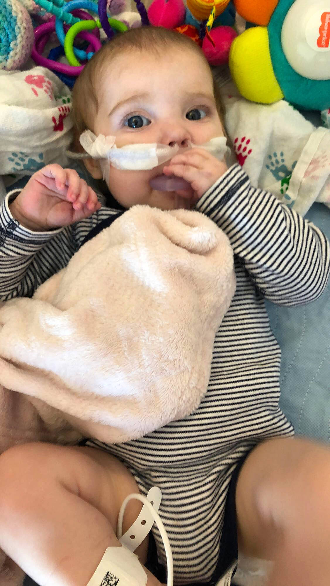 Teagan is registered to the contest to win money with this photo: baby, cheek, child, comfort, doll, eye, eyebrow, eyelash, finger, gesture, happy, lip, mouth, nail, nose, person, skin, thumb, toddler, wood