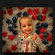 Silas joined the competition — help win amazing prizes! baby, blue_bows, celebration, child, christmas_pajamas, cute, face, festive, gift_bows, green_bows, happy, holiday, holiday_theme, infant, lying_down, portrait, red_bows, smiling, soft_surface, white_bows