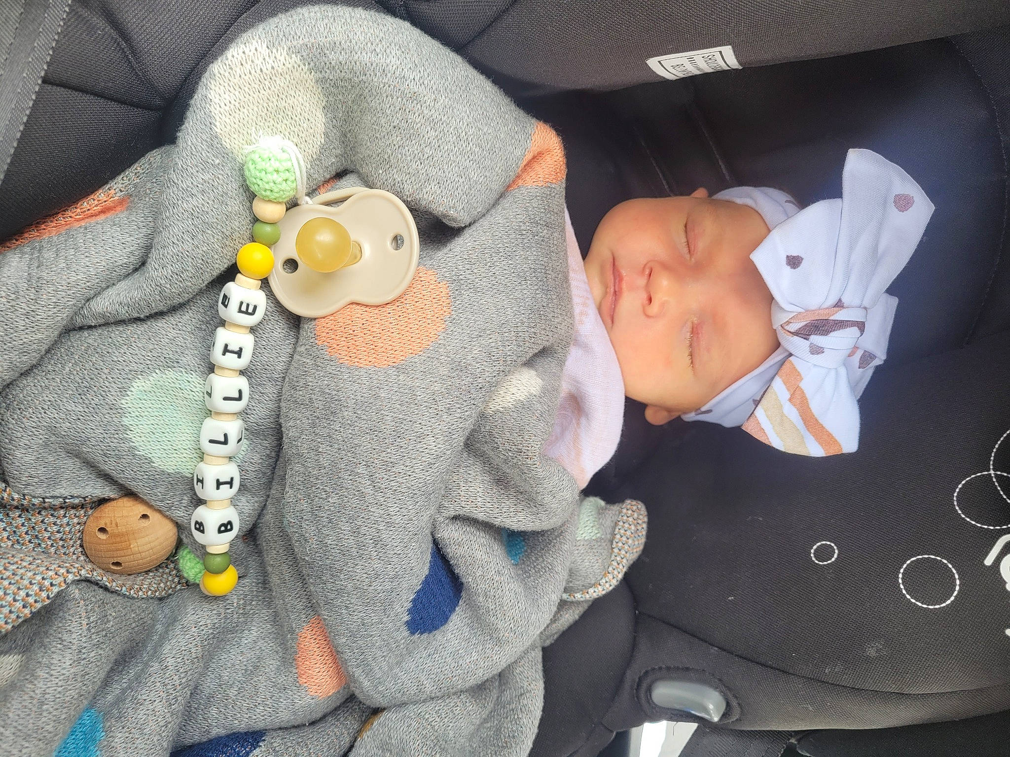 Billie is registered to the contest to win money with this photo: auto_part, baby, baby_products, baby_safety, baby_sleeping, baby_toys, button, car_seat, child, comfort, grey, headwear, linens, nail, nap, pattern, person, plush, stuffed_toy, textile