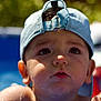 Eden a rejoint le concours — aidez-le/la à gagner de superbes lots ! child, toddler, boy, water, pool, cap, hat, face, portrait, summer, outdoor, wet, skin, expression, curious, closeup, water_droplets, person, headwear, background_blur