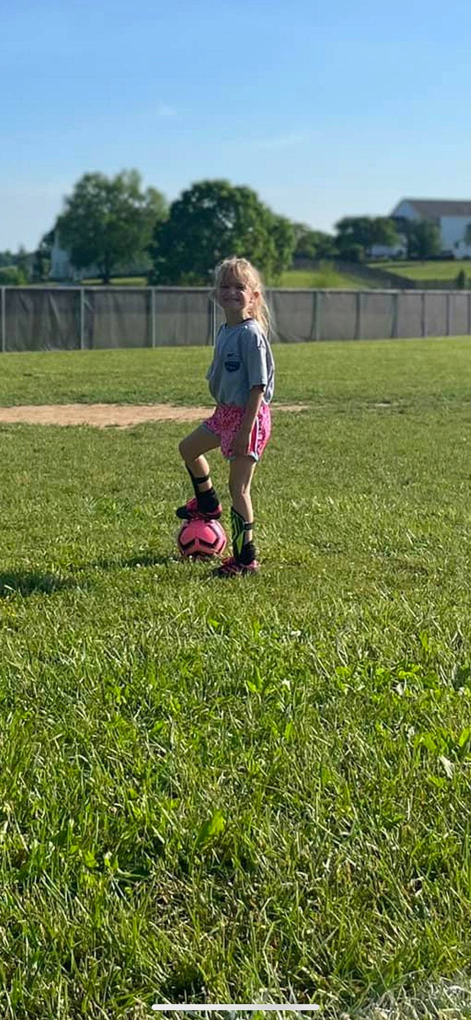 Aubreigh is registered to the contest to win money with this photo: agriculture, ball, competition_event, fence, grass, grass_family, grassland, happy, joy, lawn, meadow, people_in_nature, person, plant, player, prairie, recreation, sky, soccer_ball, sports_equipment