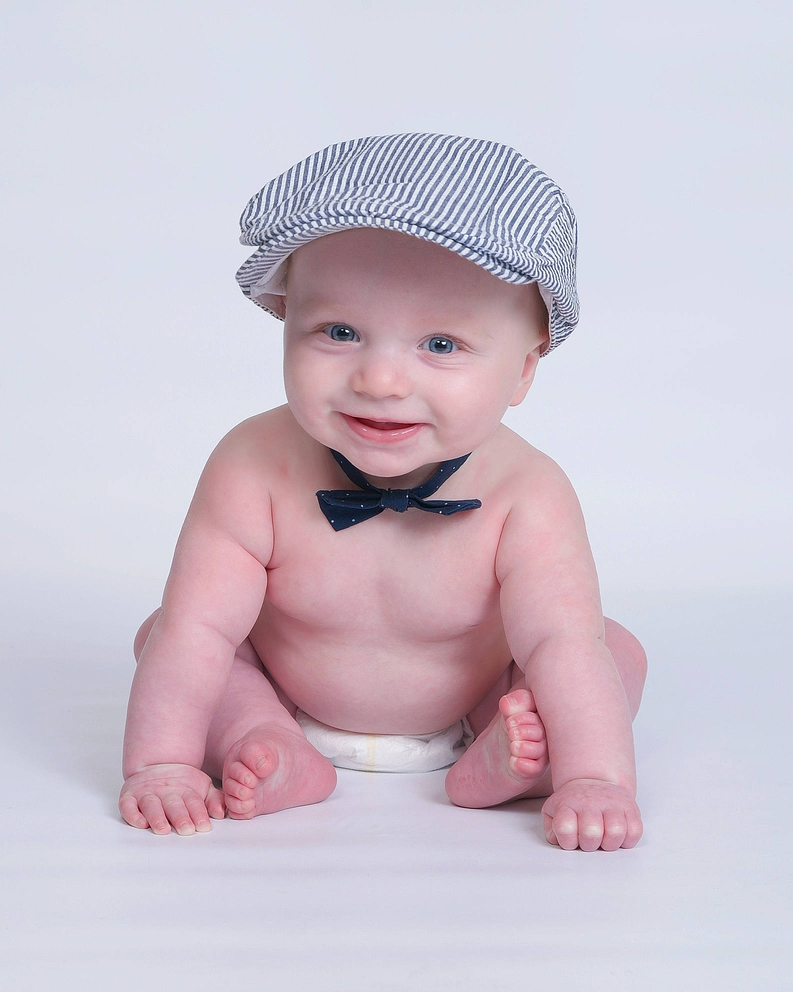 Calvin is registered to the contest to win money with this photo: arm, baby, baby_toddler_clothing, cap, child, face, fashion_accessory, flash_photography, gesture, hair_accessory, happy, head, headwear, joy, lip, neck, person, skin, sleeve, smile