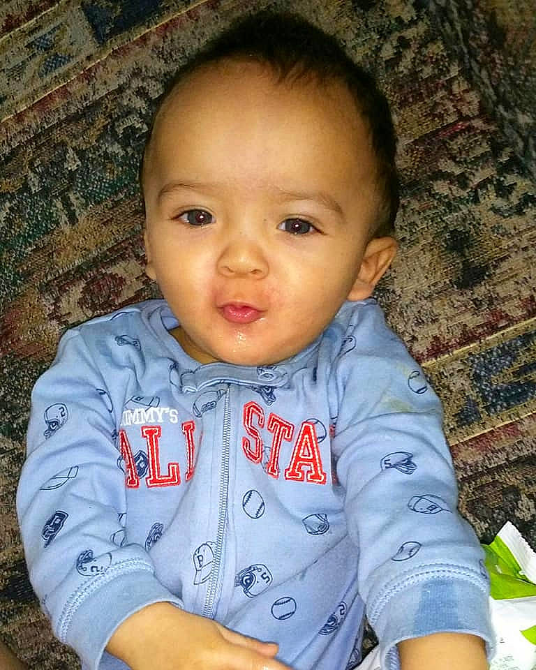 Shakeem is registered to the contest to win money with this photo: baby, cheek, child, chin, eye, face, forehead, head, iris, lip, male, nose, person, sitting, skin, smile, toddler