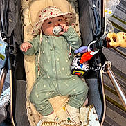 Asiya is registered to the contest to win money with this photo: baby, stroller, pacifier, hat, blanket, toy, footwear, onesie, infant, child, indoor, comfort, cute, playful, fabric, person, smile, headwear, relaxation, soft