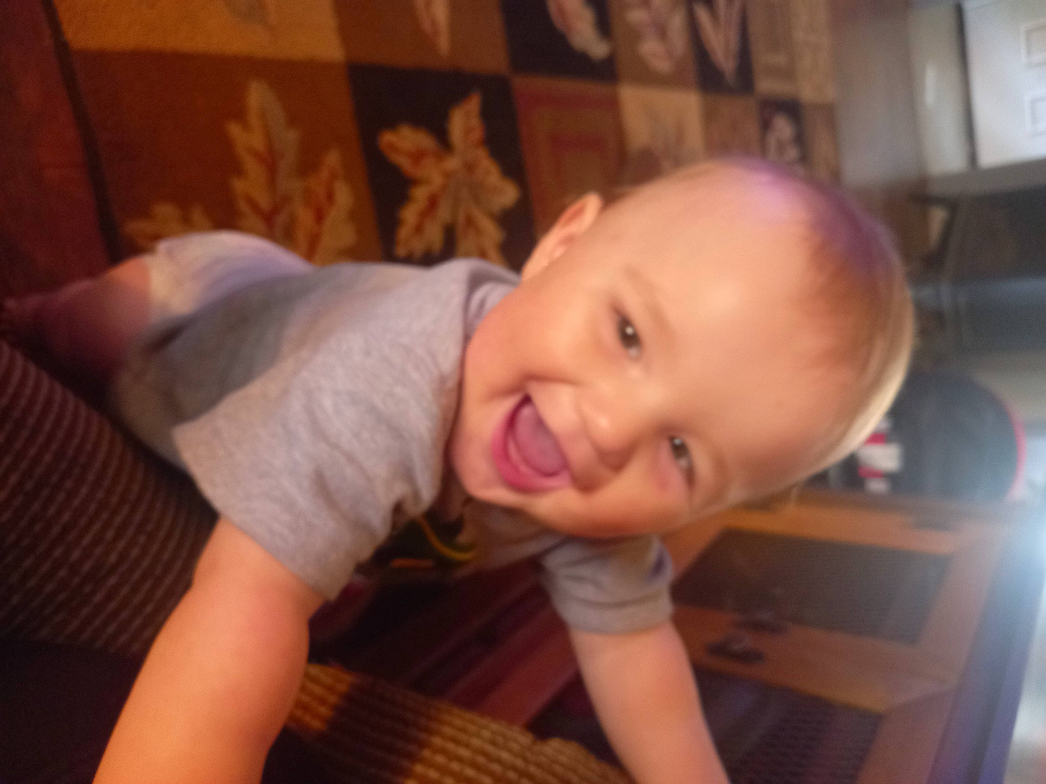 Corey is registered to the contest to win money with this photo: baby, baby_laughing, baby_toddler_clothing, cheek, chest, child, flooring, fun, happy, hardwood, head, iris, mouth, nose, person, sitting, skin, smile, thumb, toddler