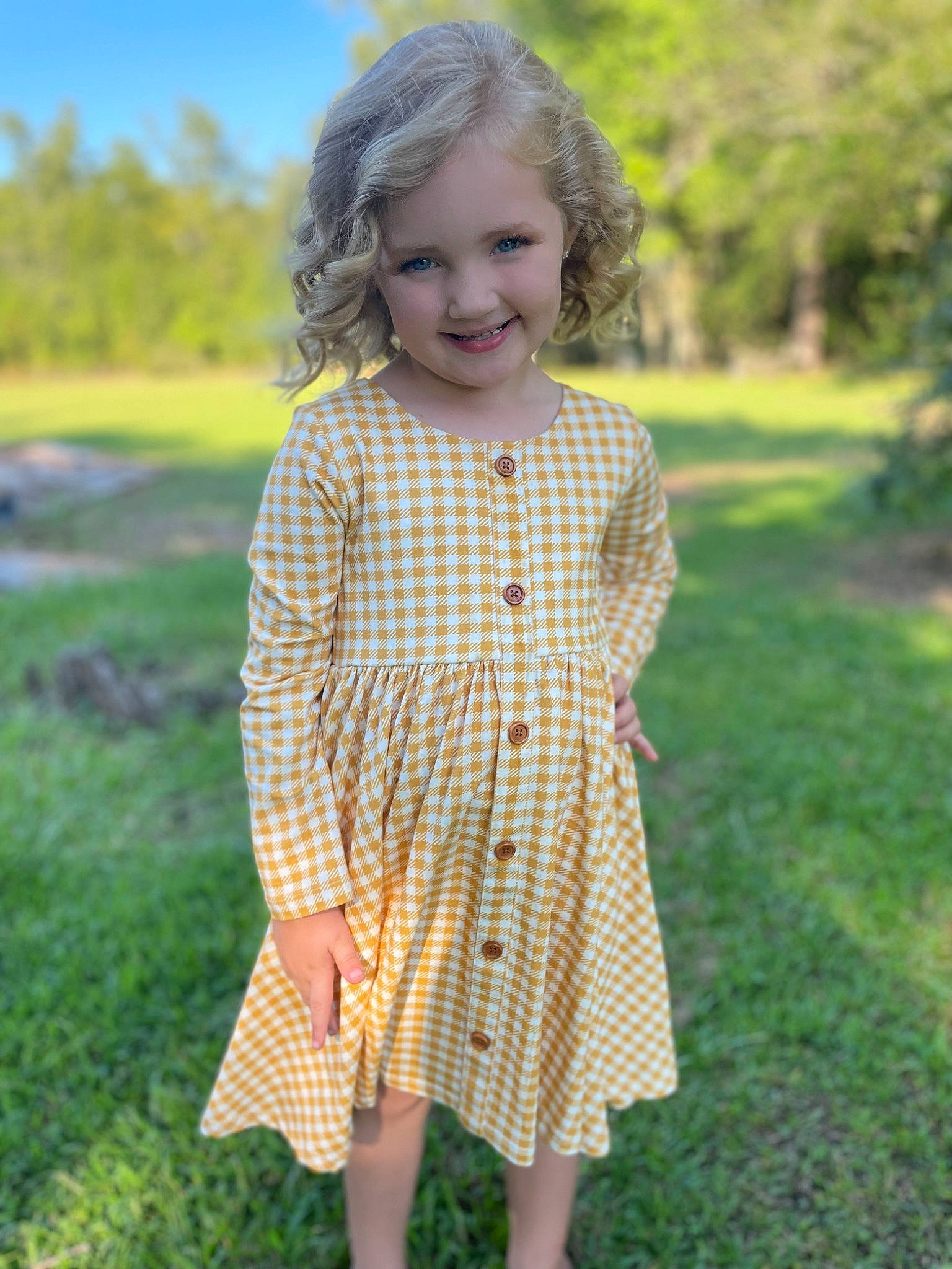 Anslee joined the competition — help win amazing prizes! baby_toddler_clothing, day_dress, dress, face, grass, grass_family, hair, happy, head, joy, meadow, nature, one_piece_garment, pattern, people_in_nature, person, plaid, plant, sleeve, smile