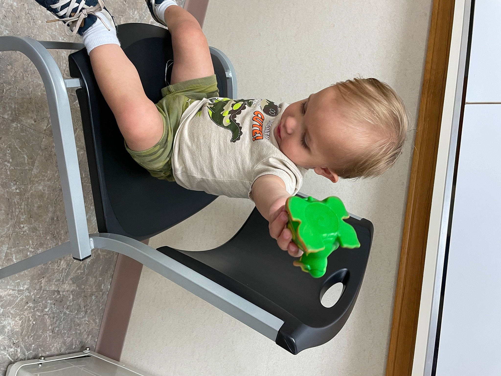 Houston is registered to the contest to win money with this photo: arm, baby, baby_products, baby_toddler_clothing, child, comfort, elbow, fun, human_body, human_leg, knee, leisure, person, room, shorts, sitting, sleeve, sock, t_shirt, thigh