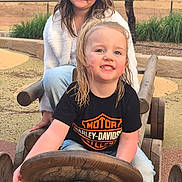 Ruby joined the competition — help win amazing prizes! child, children, outdoor, playground, wooden_toy, toy_car, steering_wheel, happy, smiling, casual_clothing, nature, grass, tree, daylight, fun, friends, park, wood, person, play