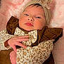 baby, blanket, bow, brown_clothing, child, closeup, cozy, cute, face, hand, headband, indoors, infant, leopard_print, newborn, pink_blanket, portrait, resting, sleepwear, soft_texture