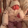 baby, baby_gloves, blanket, car_seat, child, clothing, comfort, cute, footwear, fur, hat, indoor, infant, pink_pants, pom_pom, portrait, resting, sleeping, soft_texture, warm