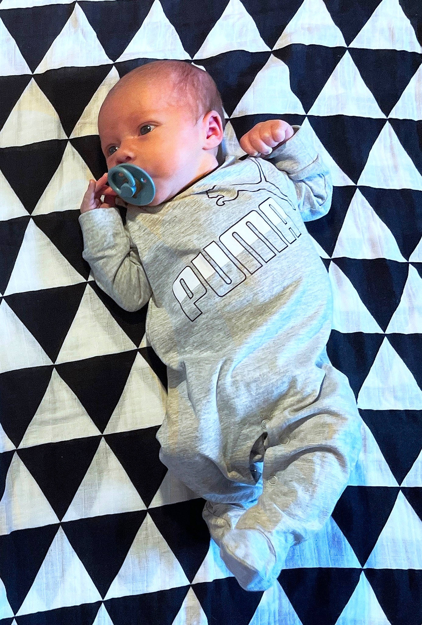 Cassius is registered to the contest to win money with this photo: baby, baby_toddler_clothing, child, flooring, font, fun, gesture, illustration, indoor_games_and_sports, leisure, linens, pattern, person, play, recreation, sitting, sleeve, space, textile, toddler