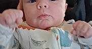 Montie joined the competition — help win amazing prizes! baby, blue_eyes, child, clothing, couch, cozy, cute, dinosaur_pattern, expression, face, fist, hand, indoor, infant, leather, newborn, onesie, person, portrait, soft_lighting