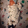Montie is registered to the contest to win money with this photo: baby, newborn, sleeping, onesie, hat, blanket, pacifier, infant, cute, peaceful, child, footwear, pattern, soft, resting, indoor, portrait, cozy, small, sleep