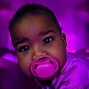 A'Maya is registered to the contest to win money with this photo: adorable, baby, background, child, closeup, clothing, cute, eyeshadow, face, glowing, infant, pacifier, person, pink, portrait, purple, shiny, soft, sparkle, young