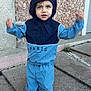 Naïm participe au concours pour gagner de l'argent avec cette photo : toddler, child, hooded_jacket, tracksuit, sneakers, outdoor, concrete, steps, curious_expression, blue_clothing, person, young_child, casual_wear, daylight, urban, sidewalk, standing, face, hands, portrait