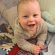 Jesse joined the competition — help win amazing prizes! baby, infant, child, smiling, happy, bed, blanket, quilt, plush_toy, stuffed_animal, onesie, crawling, nursery, face, cheeks, hands, eyes, portrait, cozy, playtime