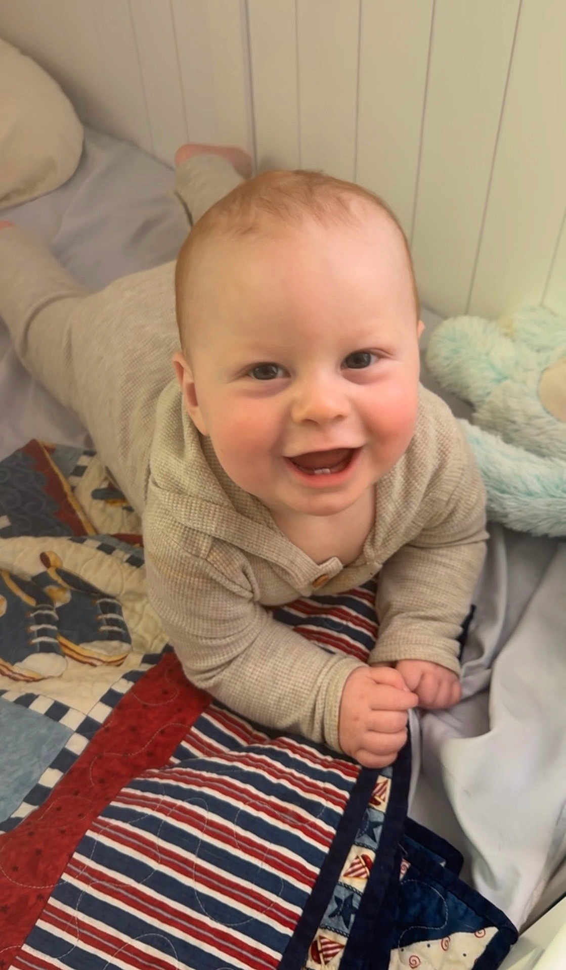 Jesse joined the competition — help win amazing prizes! baby, infant, child, smiling, happy, bed, blanket, quilt, plush_toy, stuffed_animal, onesie, crawling, nursery, face, cheeks, hands, eyes, portrait, cozy, playtime