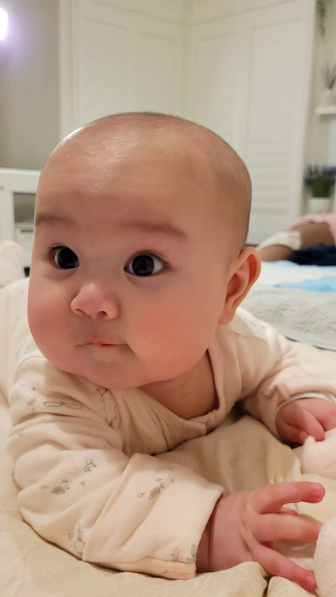 Emily is registered to the contest to win money with this photo: baby, baby_toddler_clothing, cheek, child, chin, comfort, curious, eyelash, finger, flooring, iris, nail, nose, person, sitting, skin, sleeve, thumb, toddler