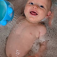 Dafydd is registered to the contest to win money with this photo: baby, bath, bubbles, water, toy, smile, happy, child, skin, face, hand, blue, play, fun, wet, cute, infant, water_toy, foam, relaxation