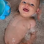 baby, bath, bubbles, water, toy, smile, happy, child, skin, face, hand, blue, play, fun, wet, cute, infant, water_toy, foam, relaxation
