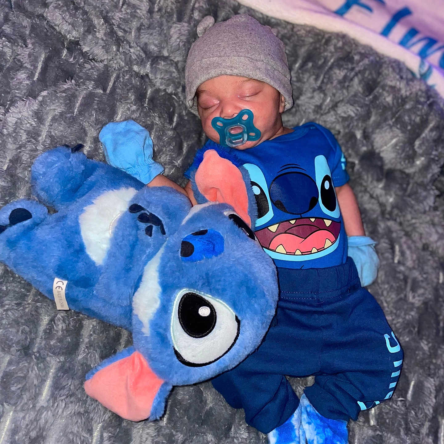 Jesrah joined the competition — help win amazing prizes! baby, blanket, blue_clothing, child, cozy, cuddling, cute, footwear, hat, indoor, mittens, pacifier, person, plush_toy, resting, sleeping, soft_texture, stuffed_animal, toddler, toy